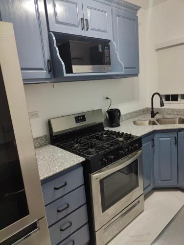 a kitchen with a stove and a microwave at Haven in Meadowbrook in Kingston
