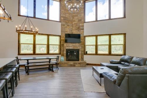 a living room with couches and a table and a fireplace at 5 Mi to Main St Breck Mtn-View Duplex with Hot Tub in Blue River