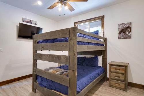 a bunk bed in a room with a ceiling fan at 5 Mi to Main St Breck Mtn-View Duplex with Hot Tub in Blue River