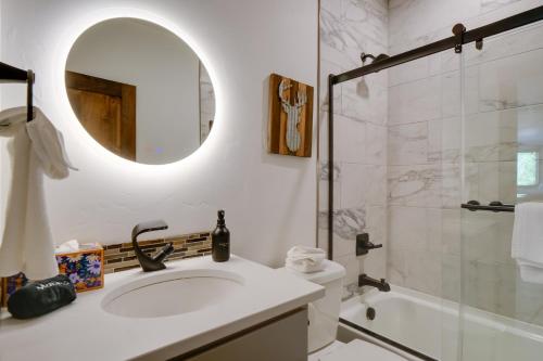 a bathroom with a sink and a shower and a mirror at 5 Mi to Main St Breck Mtn-View Duplex with Hot Tub in Blue River