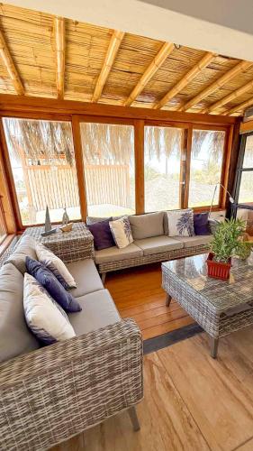 a living room with couches and a table at Terrazas Iguana in Máncora
