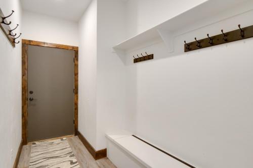 a hallway with a door in a white wall at 5 Mi to Main St Breck Mtn-View Duplex with Hot Tub in Blue River