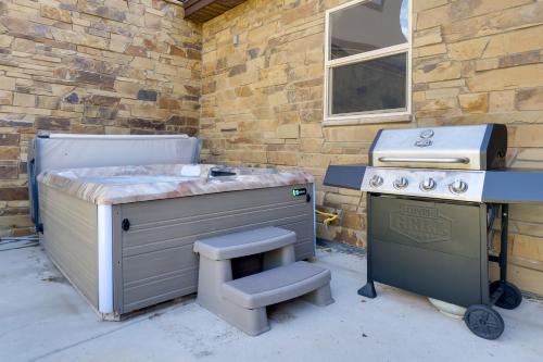 a barbecue with a stool next to a stove at 5 Mi to Main St Breck Mtn-View Duplex with Hot Tub in Blue River
