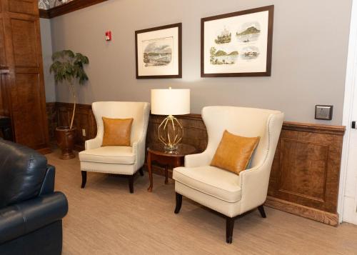 a living room with two chairs and a table at D. Hotel Suites & Spa in Holyoke