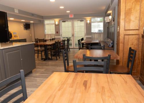 a dining room with wooden tables and chairs at D. Hotel Suites & Spa in Holyoke