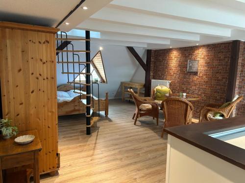 a living room with a spiral staircase and a bedroom at Ferienwohnung Klosterblick Insel Malchow mit eigenen Bootsanleger in Malchow