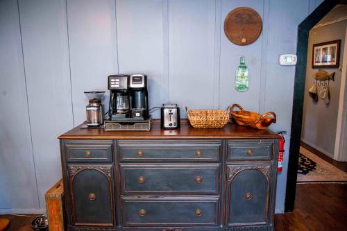 a black dresser with a coffee maker on top of it at Shore Thing in Hammondsport