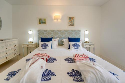 a bedroom with a large bed with blue and white at Muthu Clube Praia da Oura in Albufeira