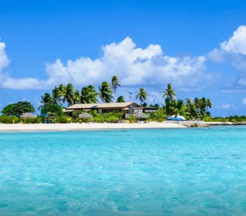 a house on a tropical island in the ocean at Te Manu Lodge Tikehau in Tikehau