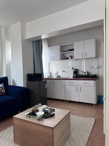 un salon avec une table et une cuisine dans l'établissement Yallo Residency, à Nairobi