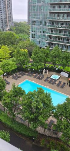 an overhead view of a swimming pool with chairs and trees at Lovely condo near Lake Ontario in Toronto