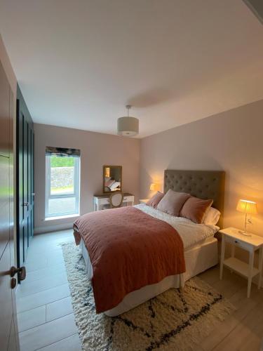 a bedroom with a large bed and a window at St Annes Coastal retreat in Cushendall