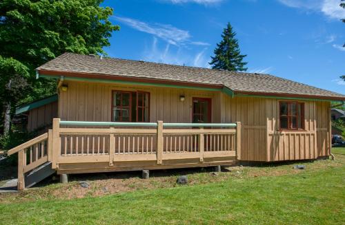 a small house with a large wooden deck at Painter's Lodge in Campbell River