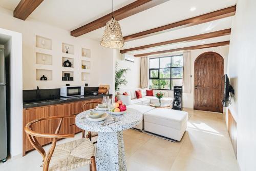 a living room with a white couch and a table at 1BR Balcony Pool Villa Near Seseh Beach in Munggu
