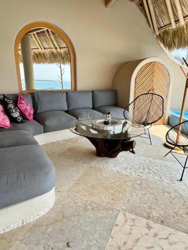 a living room with a couch and a table at Romantic Mediterranean Escape by the Sea in La Majahua
