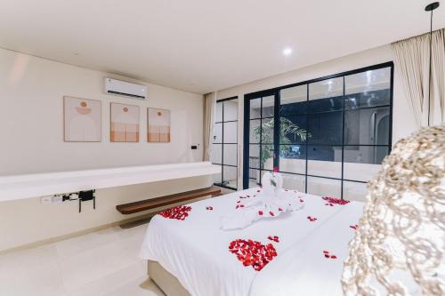 a bedroom with a white bed and a large window at 1BR Balcony Pool Villa Near Seseh Beach in Munggu