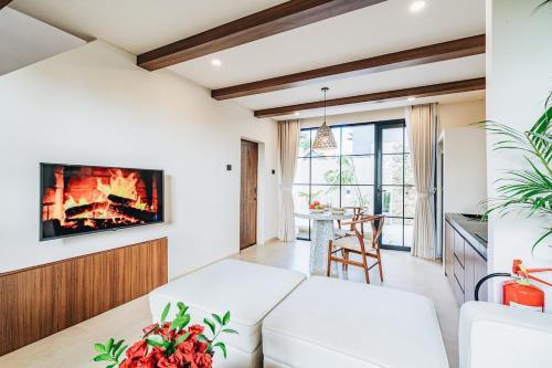a living room with a couch and a fireplace at 1BR Balcony Pool Villa Near Seseh Beach in Munggu