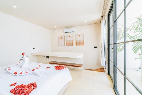 a bedroom with white walls and a large window at 1BR Balcony Pool Villa Near Seseh Beach in Munggu