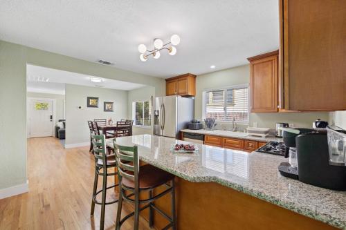 a kitchen with a counter and some bar stools at Cozy Home 7 minutes Walk to UC Davis Sacramento in Sacramento