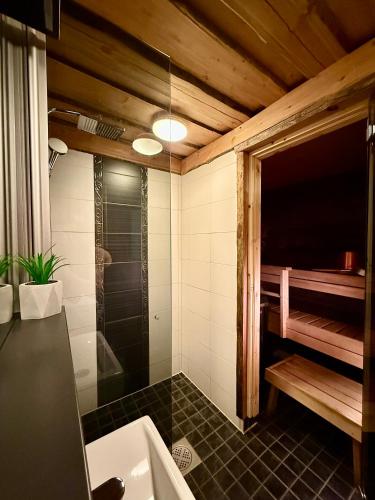 a bathroom with a shower and a sink at Ruka View at the Slopes Ski in, Family & Bike Park, National Park, hike trails - Lapland Villas in Ruka