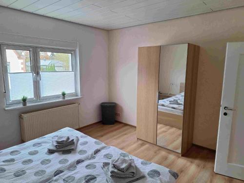 a bedroom with a mirror and a bed in it at Ferienwohnung Missionshausstrasse in Sankt Wendel