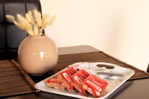 a plate of food on a table with a vase at Stv Royal Appartments in Areopolis