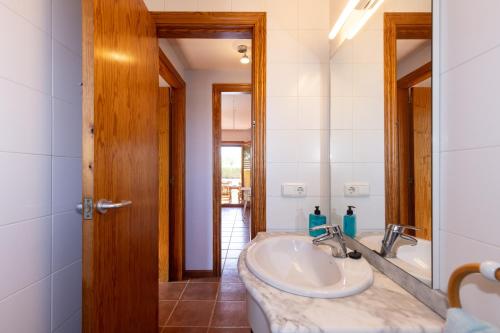 a bathroom with a sink and a mirror at Villa with private pool 3 minutes from the beach in Montroig
