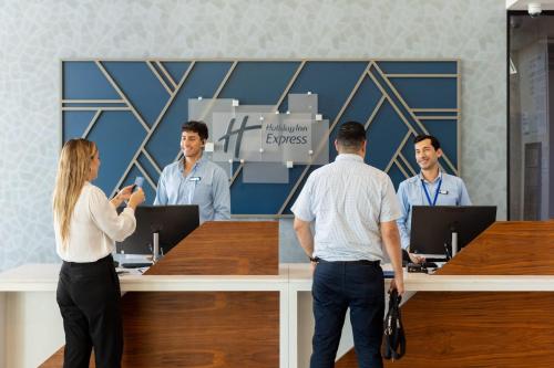 a group of people standing around a reception desk at Holiday Inn Express & Suites Mazatlan by IHG in Mazatlán