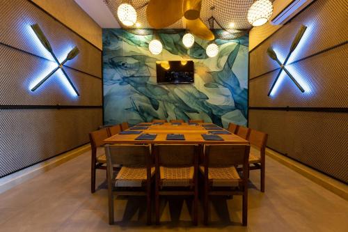 a dining room with a table and some lights at Holiday Inn Express & Suites Mazatlan by IHG in Mazatlán