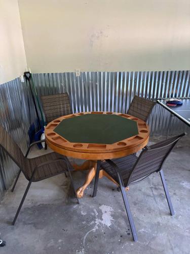 a ping pong table with two chairs around it at Kevins Place near PawPaw Lake in Watervliet