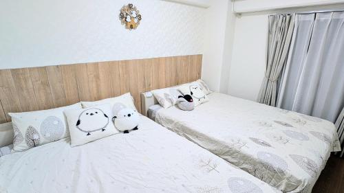 two beds with hello kitty pillows in a bedroom at MIYAVI#101 3min walk from Narimasu Station, up to 6 people, spacious popular character room, Tokyo's largest Don Quijote in Tokyo