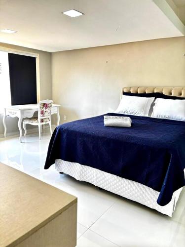 a bedroom with a bed and a tv and a chair at Pousada Sousa Residencial Qrt1 in Sousa