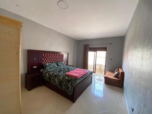 a bedroom with a bed and a chair at Haute Anza in Agadir
