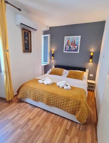 a bedroom with a large bed with two towels on it at INCHY ACCOMMODATION - in the center of Diocletian's Palace in Split