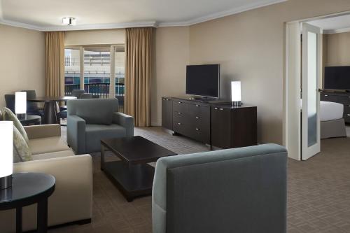 a living room with a couch and a tv at InterContinental Toronto Centre by IHG in Toronto