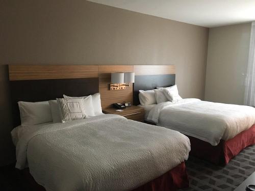 two beds in a hotel room with two bedsskirts at TownePlace Suites by Marriott Charleston Mt. Pleasant in Charleston