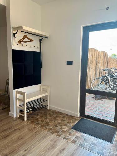 a living room with a tv and a window at Apartament pod Świerkami in Pisz