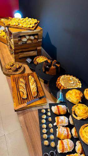 a table filled with different types of bread and pastries at ibis Maceio Pajuçara in Maceió