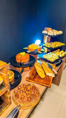 a table topped with lots of different types of food at ibis Maceio Pajuçara in Maceió