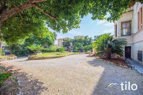 a gravel driveway in front of a house at Villa Aranci | Historical Residence | By Tilo Lux in Genova