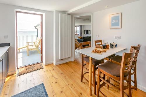 a kitchen and dining room with a table and chairs at Barachy in Coverack