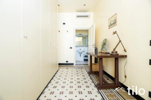 a hallway with a table and a floor at Villa Aranci | Historical Residence | By Tilo Lux in Genova