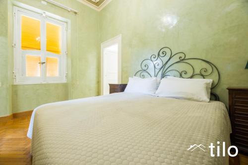 a bedroom with a large bed with a white bedspread at Villa Aranci | Historical Residence | By Tilo Lux in Genova
