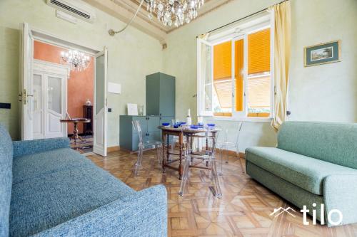 a living room with two couches and a table at Villa Aranci | Historical Residence | By Tilo Lux in Genova