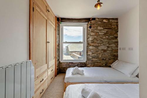 Ένα ή περισσότερα κρεβάτια σε δωμάτιο στο Albatross Cottage