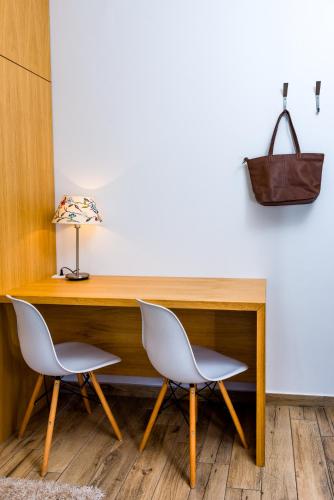 two chairs sitting in front of a wooden desk at Arena Penthouse Apartments in Belgrade