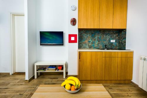 a bowl of bananas in a kitchen with a sink at Arena Penthouse Apartments in Belgrade
