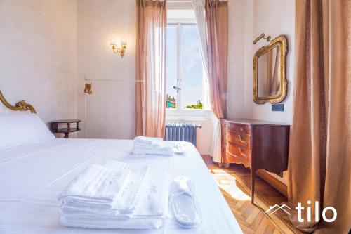 a bedroom with a bed with a mirror and a dresser at Villa Aranci | Historical Residence | By Tilo Lux in Genova