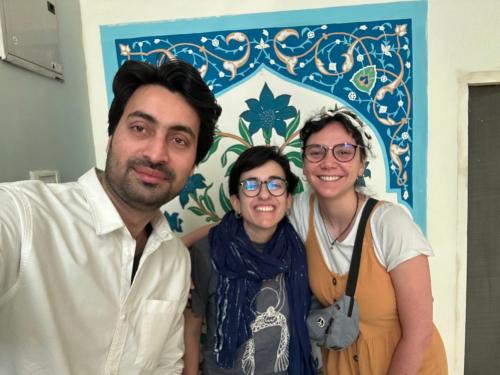 a man and two women standing in front of a wall at Max Guest House in Agra