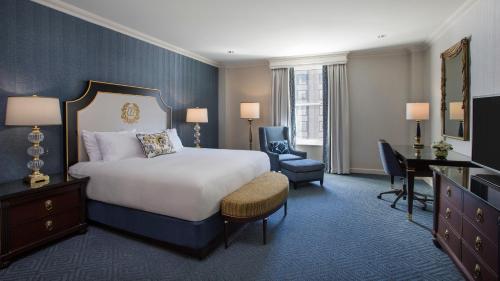 a hotel room with a bed and a desk and chair at Willard InterContinental Washington by IHG in Washington
